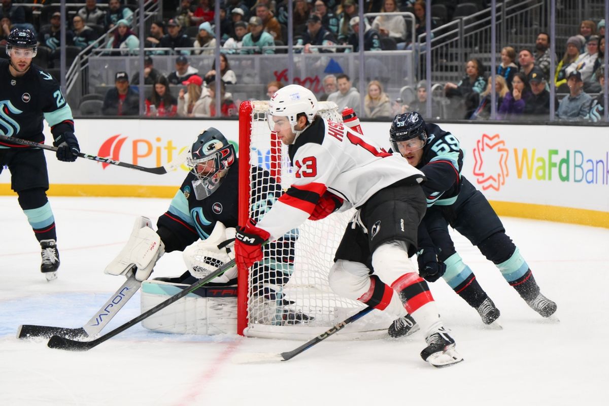 Jan 6, 2025; Seattle, Washington, USA; Seattle Kraken goaltender Philipp Grubauer (31) blocks a goal shot attempt by New Jersey Devils center Nico Hischier (13) during the second period at Climate Pledge Arena. Mandatory Credit: Steven Bisig-Imagn Images