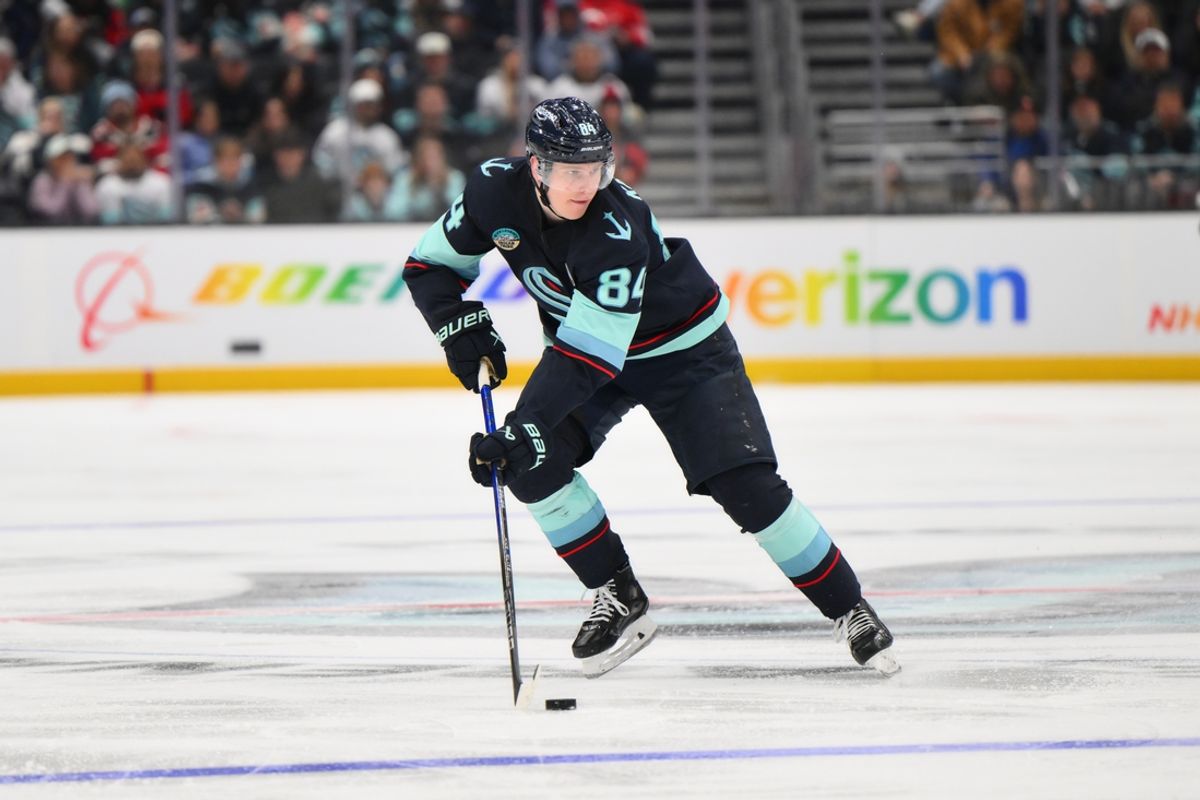 Jan 6, 2025; Seattle, Washington, USA; Seattle Kraken right wing Kaapo Kakko (84) advances the puck against the New Jersey Devils during the third period at Climate Pledge Arena. Mandatory Credit: Steven Bisig-Imagn Images