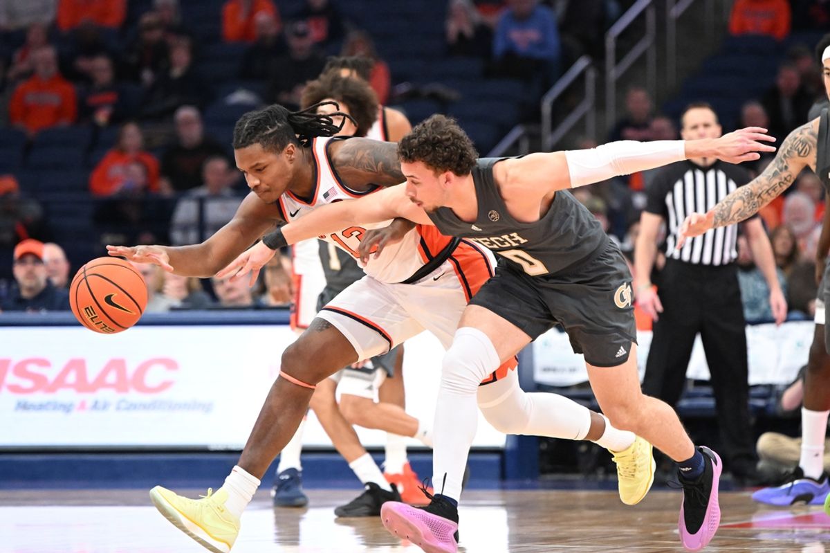 Jan 7, 2025; Syracuse, New York, USA; Syracuse Orange forward Jyare Davis (13) and Georgia Tech Yellow Jackets guard Lance Terry (0) go for a loose ball in the first half at the JMA Wireless Dome. Mandatory Credit: Mark Konezny-Imagn Images