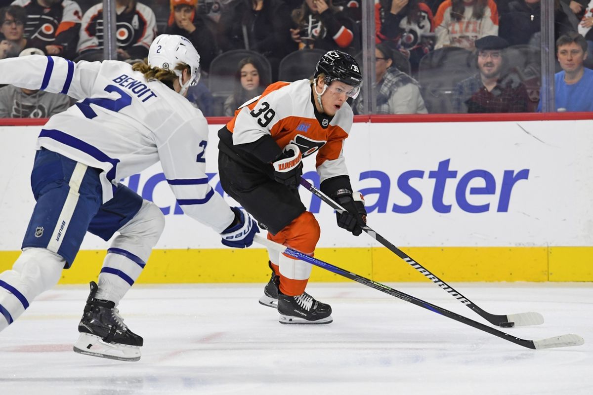 Jan 7, 2025; Philadelphia, Pennsylvania, USA; Philadelphia Flyers right wing Matvei Michkov (39) drives to the net against Toronto Maple Leafs defenseman Simon Benoit (2) during the first period at Wells Fargo Center. Mandatory Credit: Eric Hartline-Imagn Images