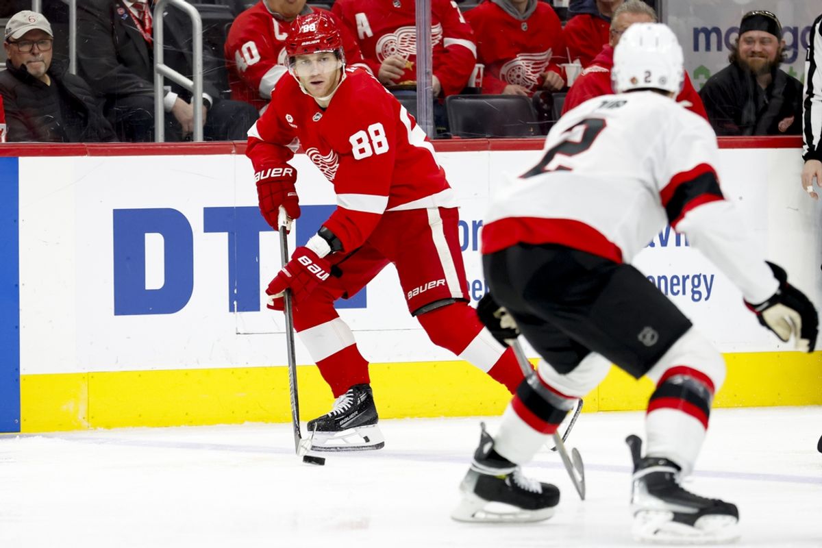 Jan 7, 2025; Detroit, Michigan, USA; Detroit Red Wings right wing Patrick Kane (88) skates with the puck defended by Ottawa Senators defenseman Artem Zub (2) in the second period at Little Caesars Arena. Mandatory Credit: Rick Osentoski-Imagn Images