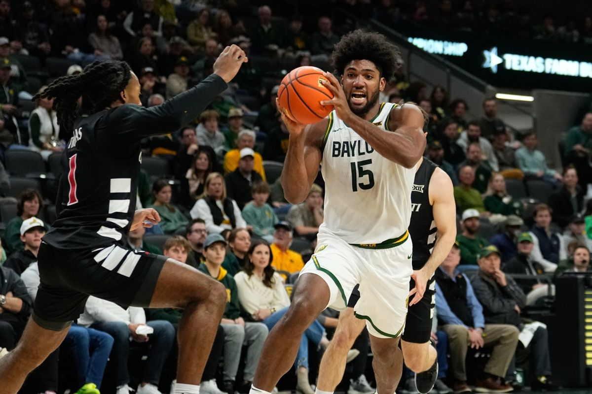 Jan 7, 2025; Waco, Texas, USA;  Baylor Bears forward Norchad Omier (15) drives to the basket against Cincinnati Bearcats guard Day Day Thomas (1) during the first half at Paul and Alejandra Foster Pavilion. Mandatory Credit: Chris Jones-Imagn Images