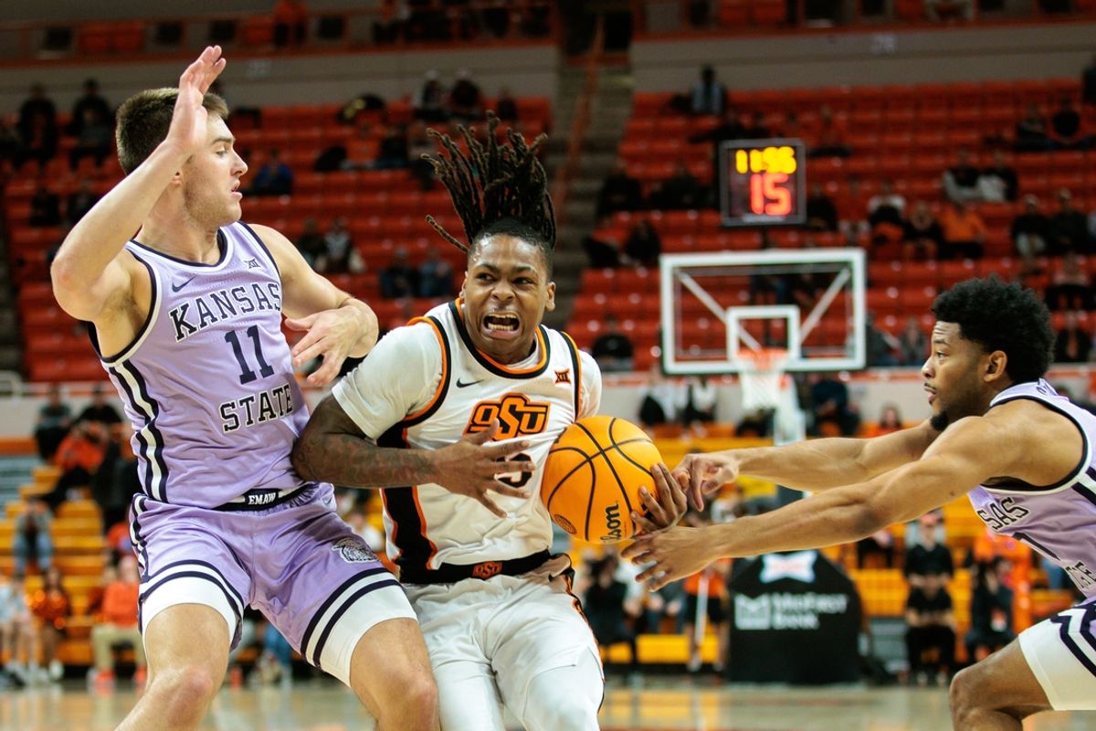 Jan 7, 2025; Stillwater, Oklahoma, USA; Oklahoma State Cowboys guard Khalil Brantley (5) drives to the basket around Kansas State Wildcats guard Brendan Hausen (11) during the first half at Gallagher-Iba Arena. Mandatory Credit: William Purnell-Imagn Images