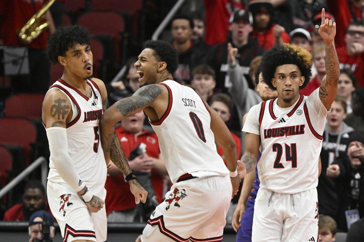 Jan 7, 2025; Louisville, Kentucky, USA; Louisville Cardinals forward James Scott (0) celebrates with guard Terrence Edwards Jr. (5) and guard Chucky Hepburn (24) during the second half against the Clemson Tigers at KFC Yum! Center. Louisville defeated Clemson 74-64. Mandatory Credit: Jamie Rhodes-Imagn Images