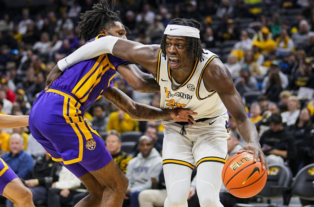 Jan 7, 2025; Columbia, Missouri, USA; Missouri Tigers guard Mark Mitchell (25) drives against LSU Tigers forward Daimion Collins (10) during the first half at Mizzou Arena. Mandatory Credit: Jay Biggerstaff-Imagn Images