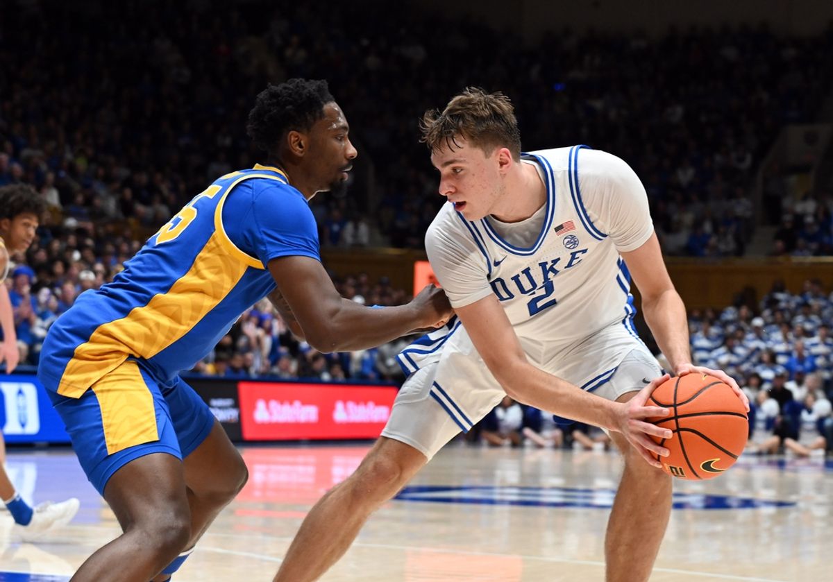 Jan 7, 2025; Durham, North Carolina, USA; Duke Blue Devils forward Cooper Flagg (2) controls the ball in front of Pitt Panthers forward Zack Austin (55) during the second half at Cameron Indoor Stadium. Mandatory Credit: Rob Kinnan-Imagn Images