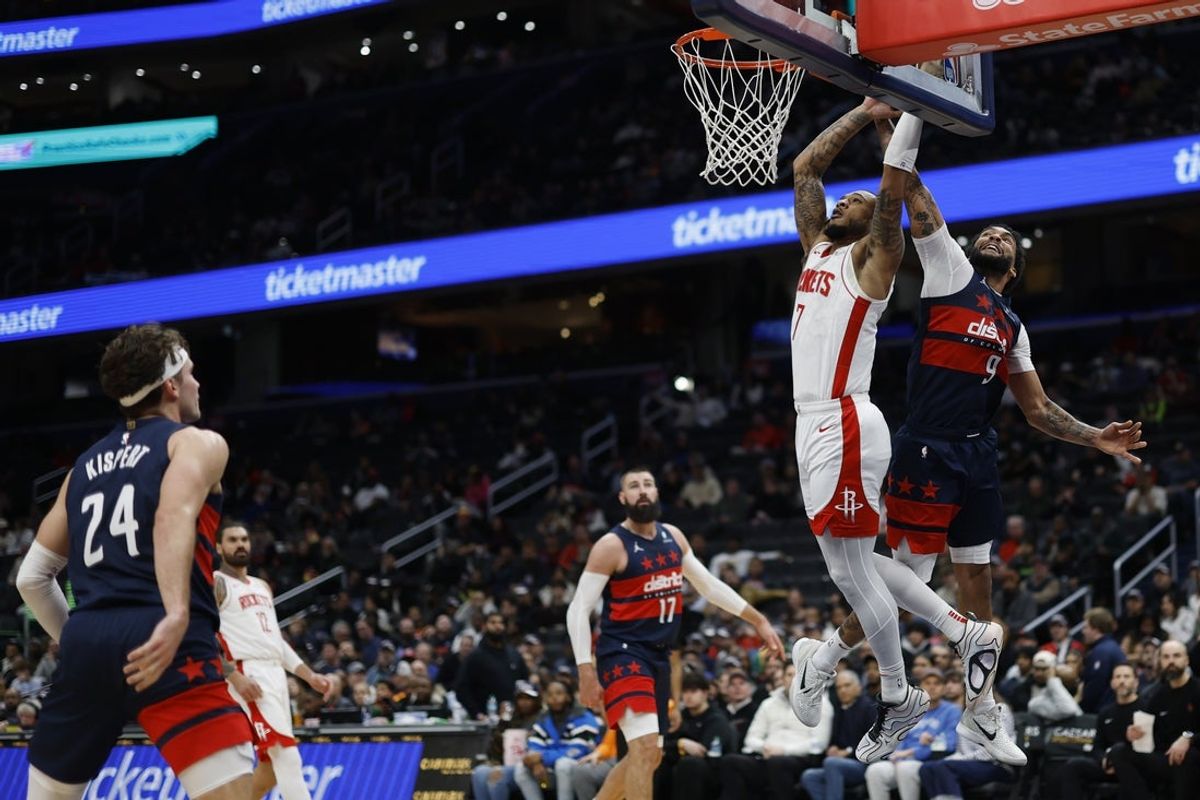 Jan 7, 2025; Washington, District of Columbia, USA; Houston Rockets forward Cam Whitmore (7) attempts to dunk the ball as Washington Wizards forward Justin Champagnie (9) defender ds in the fourth quarter at Capital One Arena. Mandatory Credit: Geoff Burke-Imagn Images