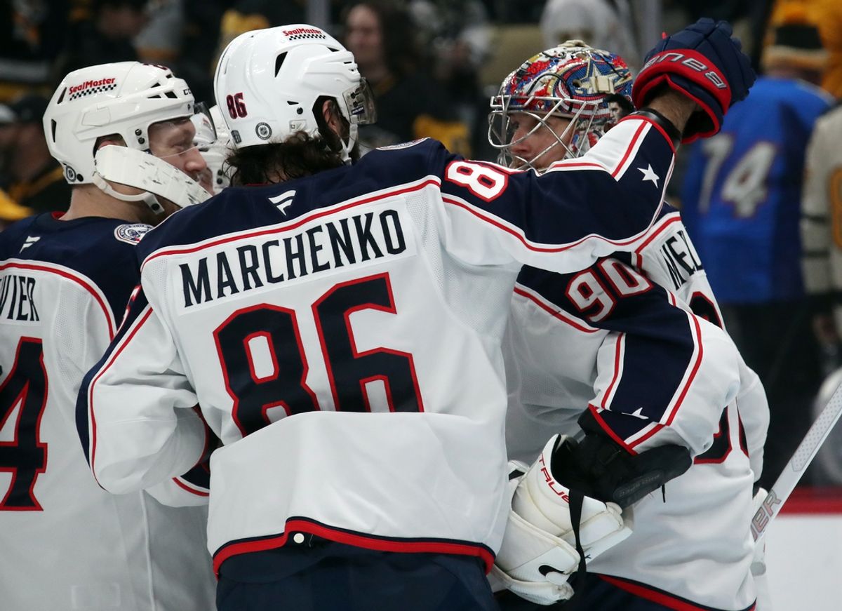 Jan 7, 2025; Pittsburgh, Pennsylvania, USA; Columbus Blue Jackets right wing Kirill Marchenko (86) and goaltender Elvis Merzlikins (90) celebrate after Marchenko scored the game-winning goal in a shootout against the Pittsburgh Penguins at PPG Paints Arena. Mandatory Credit: Charles LeClaire-Imagn Images