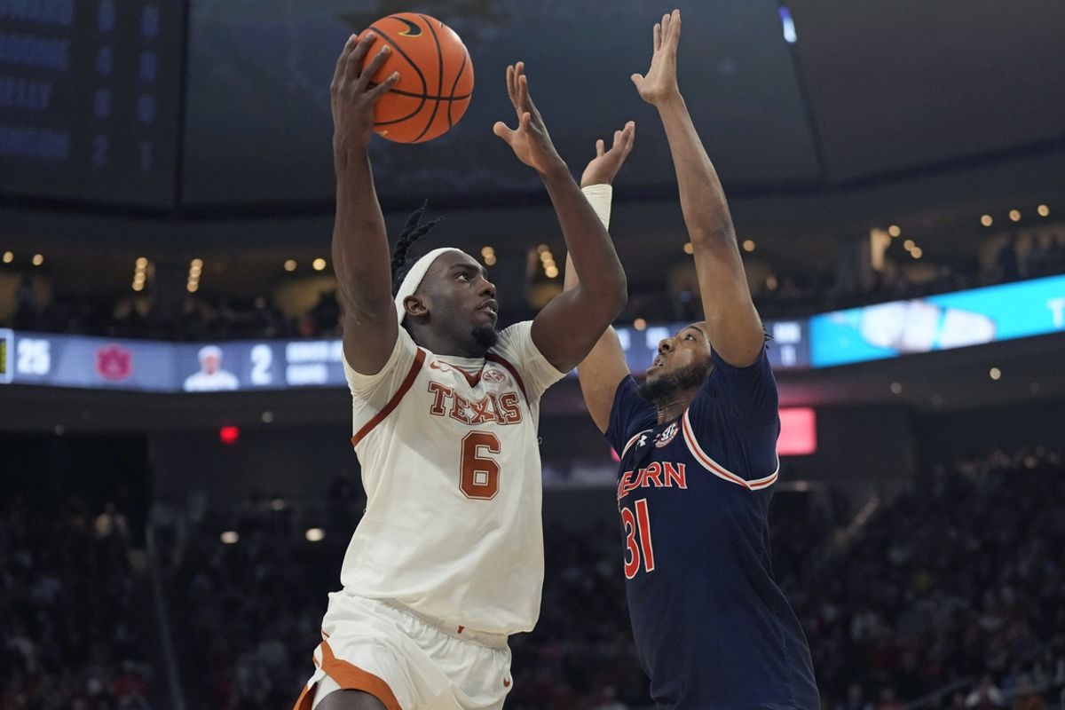 Jan 7, 2025; Austin, Texas, USA; Texas Longhorns forward Arthur Kaluma (6) shoots over Auburn Tigers forward Chaney Johnson (31) during the first half at Moody Center. Mandatory Credit: Scott Wachter-Imagn Images