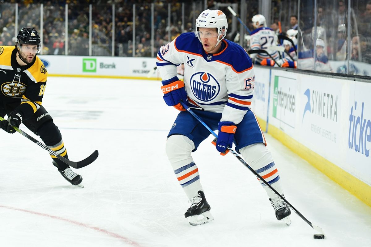 Jan 7, 2025; Boston, Massachusetts, USA;  Edmonton Oilers center Jeff Skinner (53) controls the puck while Boston Bruins center Pavel Zacha (18) defends during the second period at TD Garden. Mandatory Credit: Bob DeChiara-Imagn Images