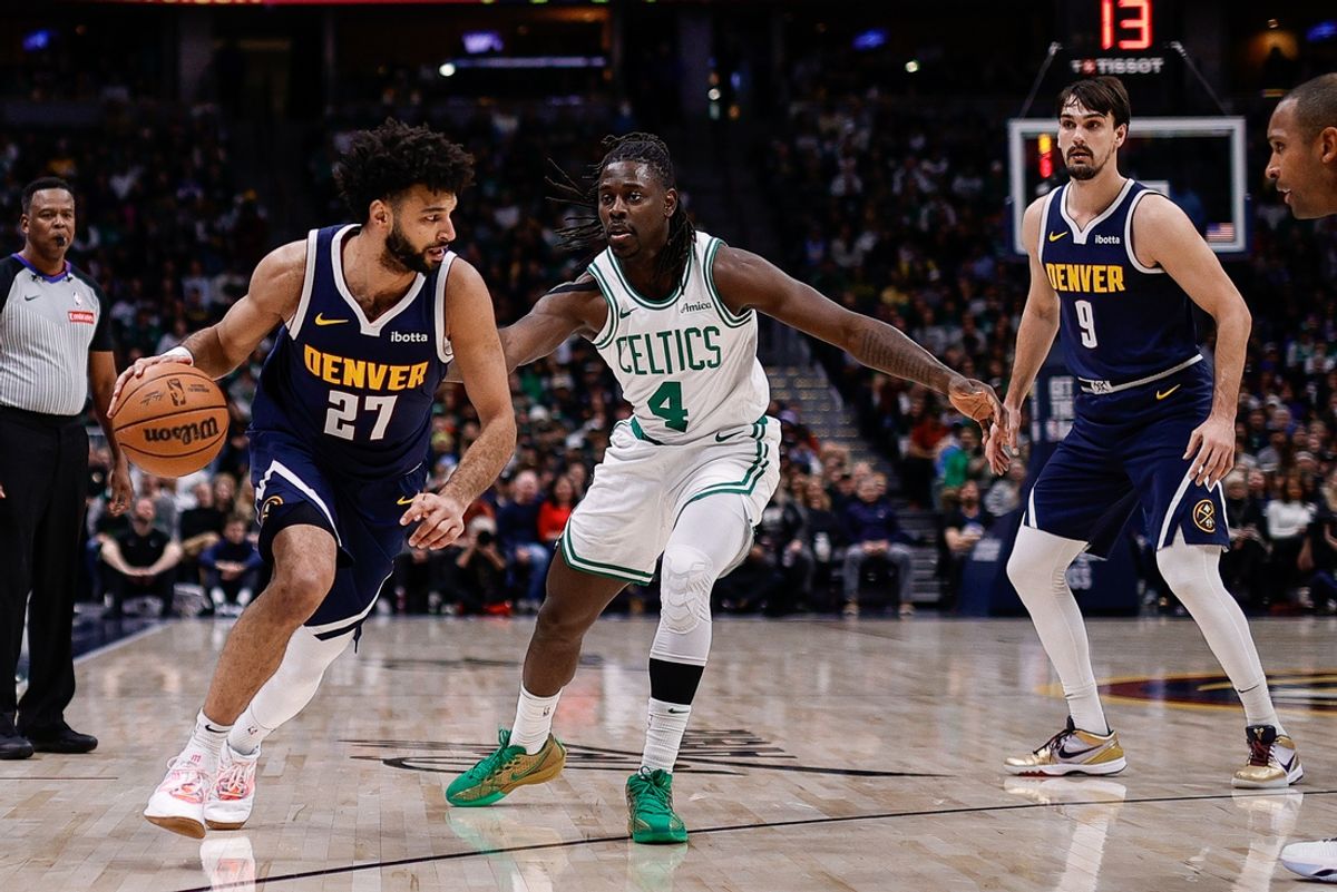 Jan 7, 2025; Denver, Colorado, USA; Denver Nuggets guard Jamal Murray (27) controls the ball against Boston Celtics guard Jrue Holiday (4) as forward Dario Saric (9) defends in the first quarter at Ball Arena. Mandatory Credit: Isaiah J. Downing-Imagn Images