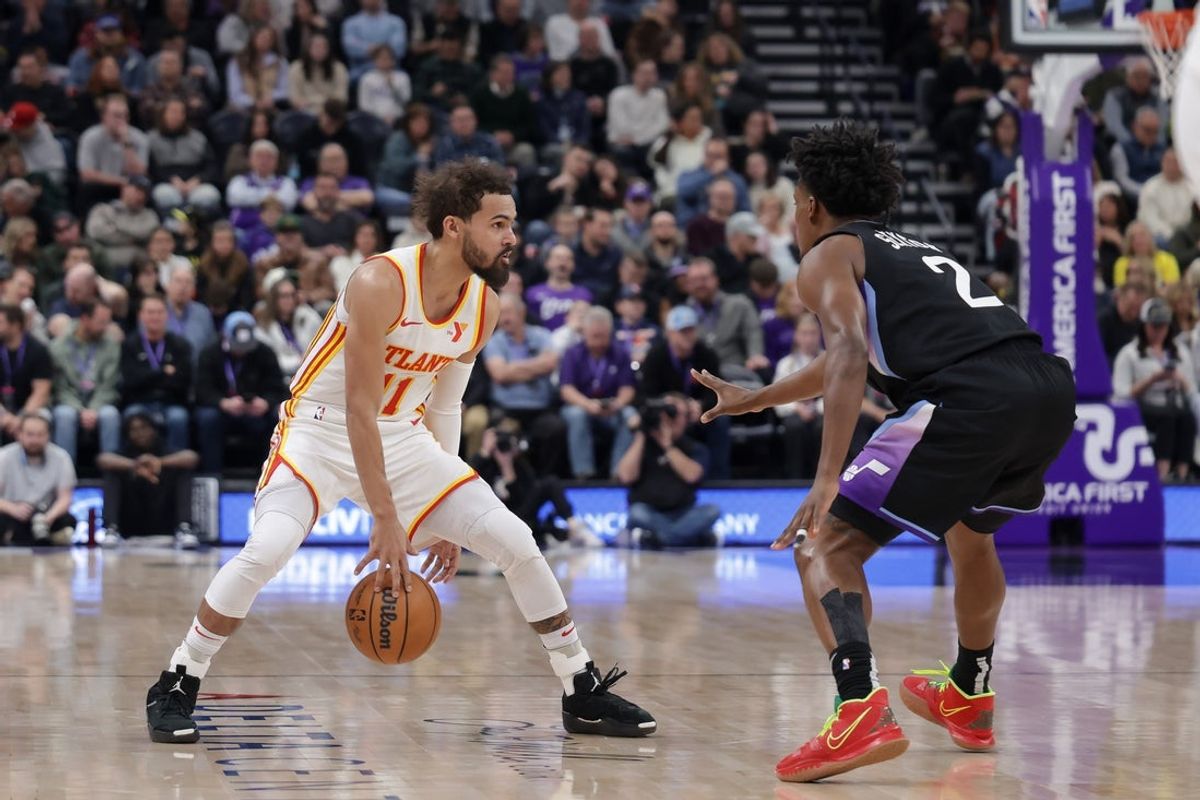 Jan 7, 2025; Salt Lake City, Utah, USA;  Atlanta Hawks guard Trae Young (11) keeps the ball from Utah Jazz guard Collin Sexton (2) during the second quarter at Delta Center. Mandatory Credit: Chris Nicoll-Imagn Images