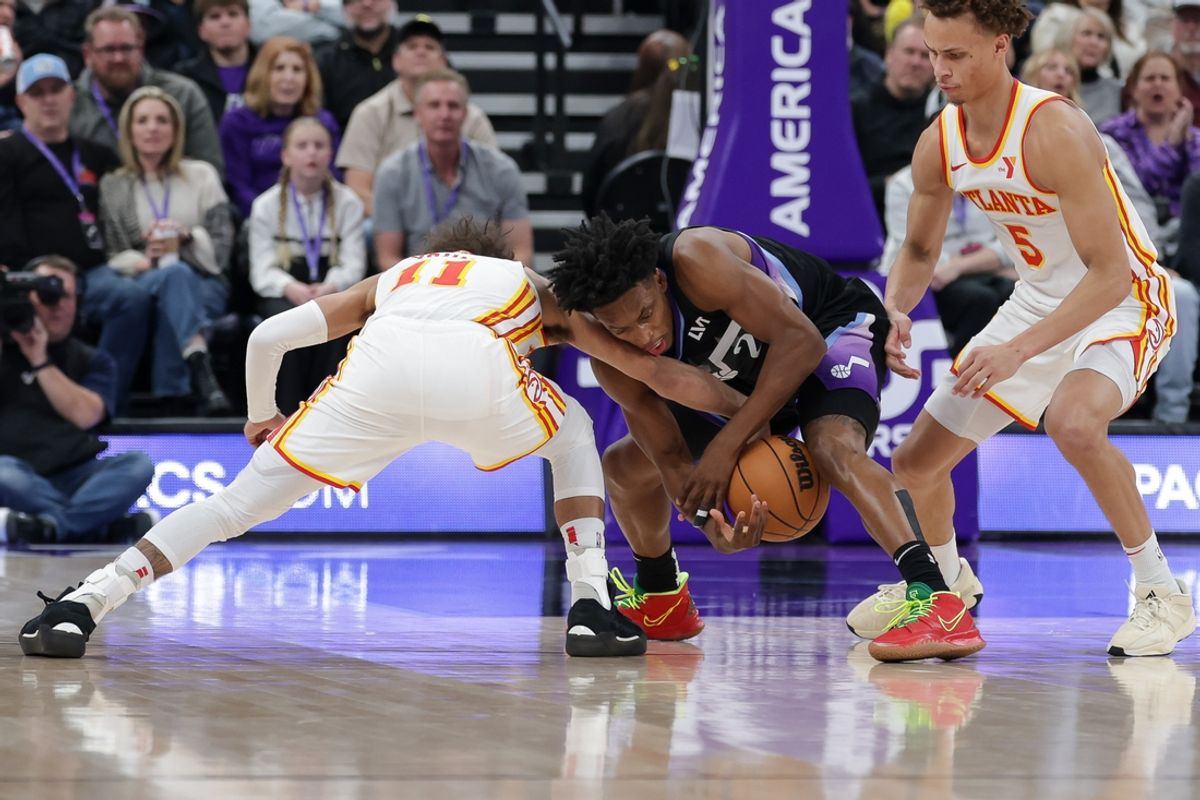Jan 7, 2025; Salt Lake City, Utah, USA;  Utah Jazz guard Collin Sexton (2) tries to keep the lose ball away from Atlanta Hawks guard Trae Young (11) during the second quarter at Delta Center. Mandatory Credit: Chris Nicoll-Imagn Images