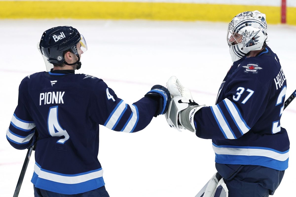 Jan 7, 2025; Winnipeg, Manitoba, CAN; Winnipeg Jets defenseman Neal Pionk (4) and Winnipeg Jets goaltender Connor Hellebuyck (37) celebrate their victory over the Nashville Predators at Canada Life Centre. Mandatory Credit: James Carey Lauder-Imagn Images