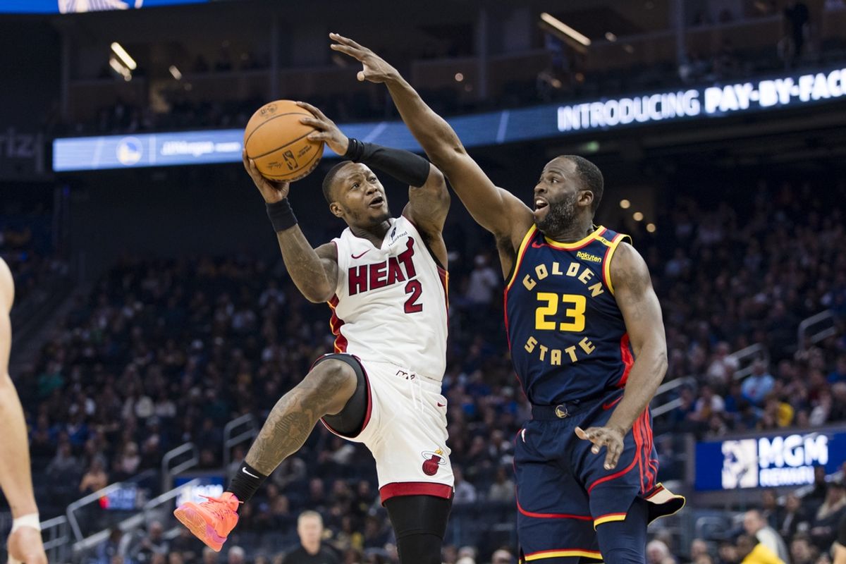 Jan 7, 2025; San Francisco, California, USA; Golden State Warriors forward Draymond Green (23) defends against Miami Heat guard Terry Rozier (2) during the second quarter at Chase Center. Mandatory Credit: John Hefti-Imagn Images