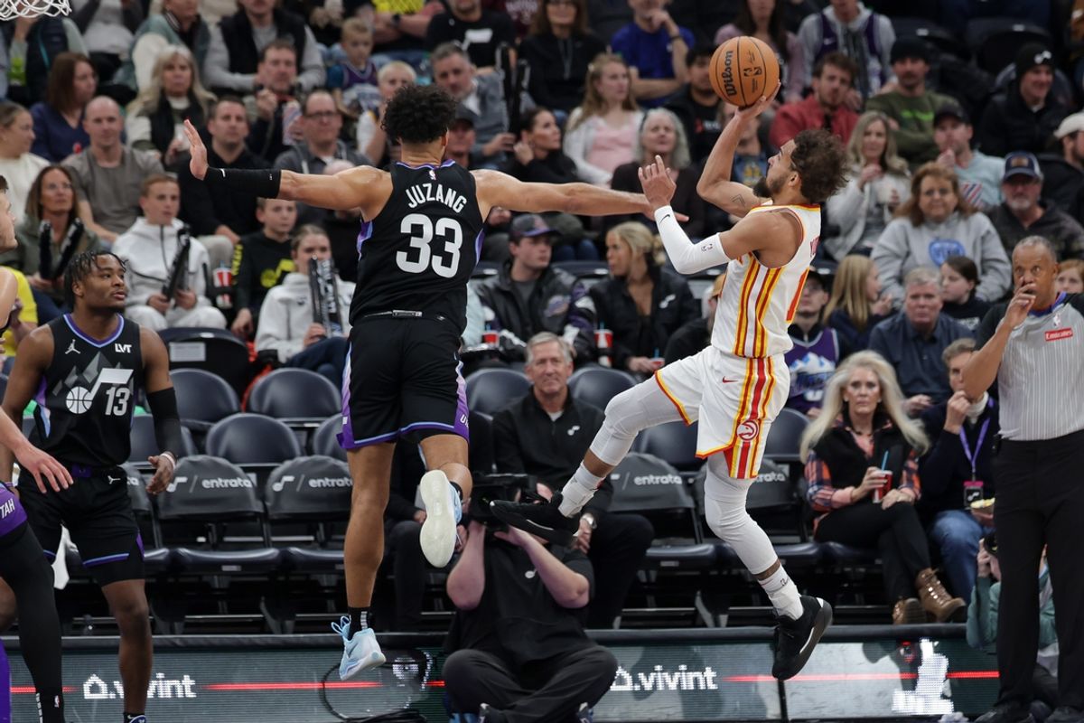 Jan 7, 2025; Salt Lake City, Utah, USA;  Atlanta Hawks guard Trae Young (11) shoots the ball past Utah Jazz guard Johnny Juzang (33) during the second half at Delta Center. Mandatory Credit: Chris Nicoll-Imagn Images