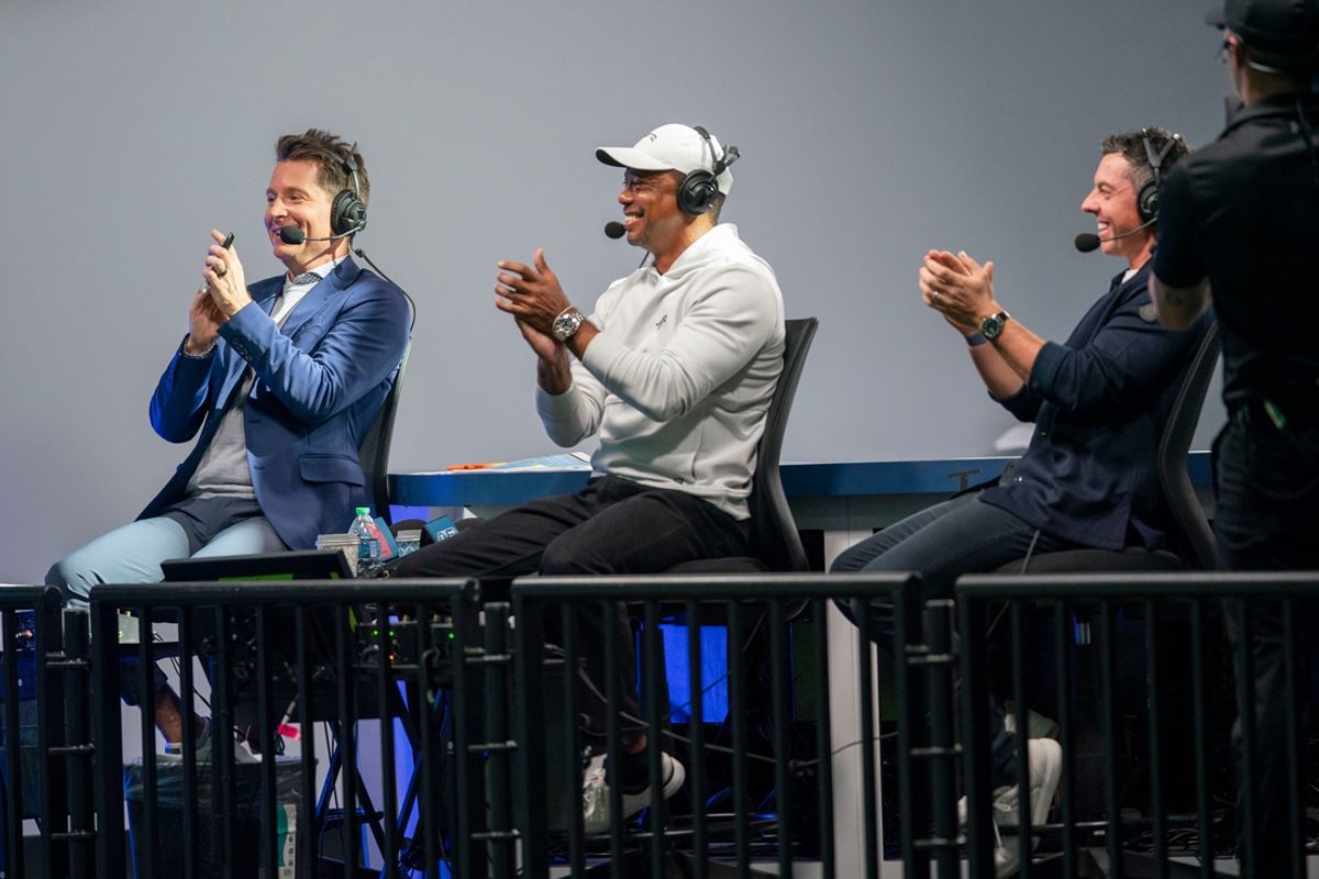 ESPN announcer Matt Barrie, Tiger Woods and Rory McIlroy react to a putt made during the inaugural match at SoFi Center, the home of TGL interactive golf league founded by Woods and McIlroy on January 7, 2025 in Palm Beach Gardens, Florida.