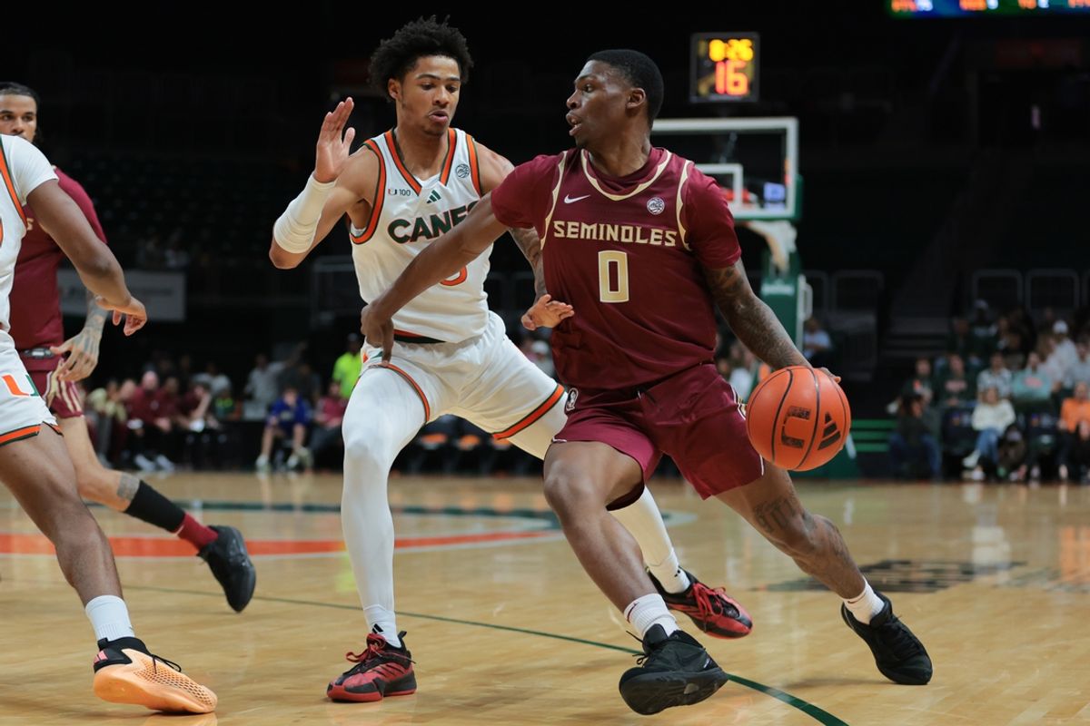 Jan 8, 2025; Coral Gables, Florida, USA; Florida State Seminoles guard Chandler Jackson (0) drives to the basket past Miami Hurricanes guard Jalil Bethea (3) during the first half at Watsco Center. Mandatory Credit: Sam Navarro-Imagn Images
