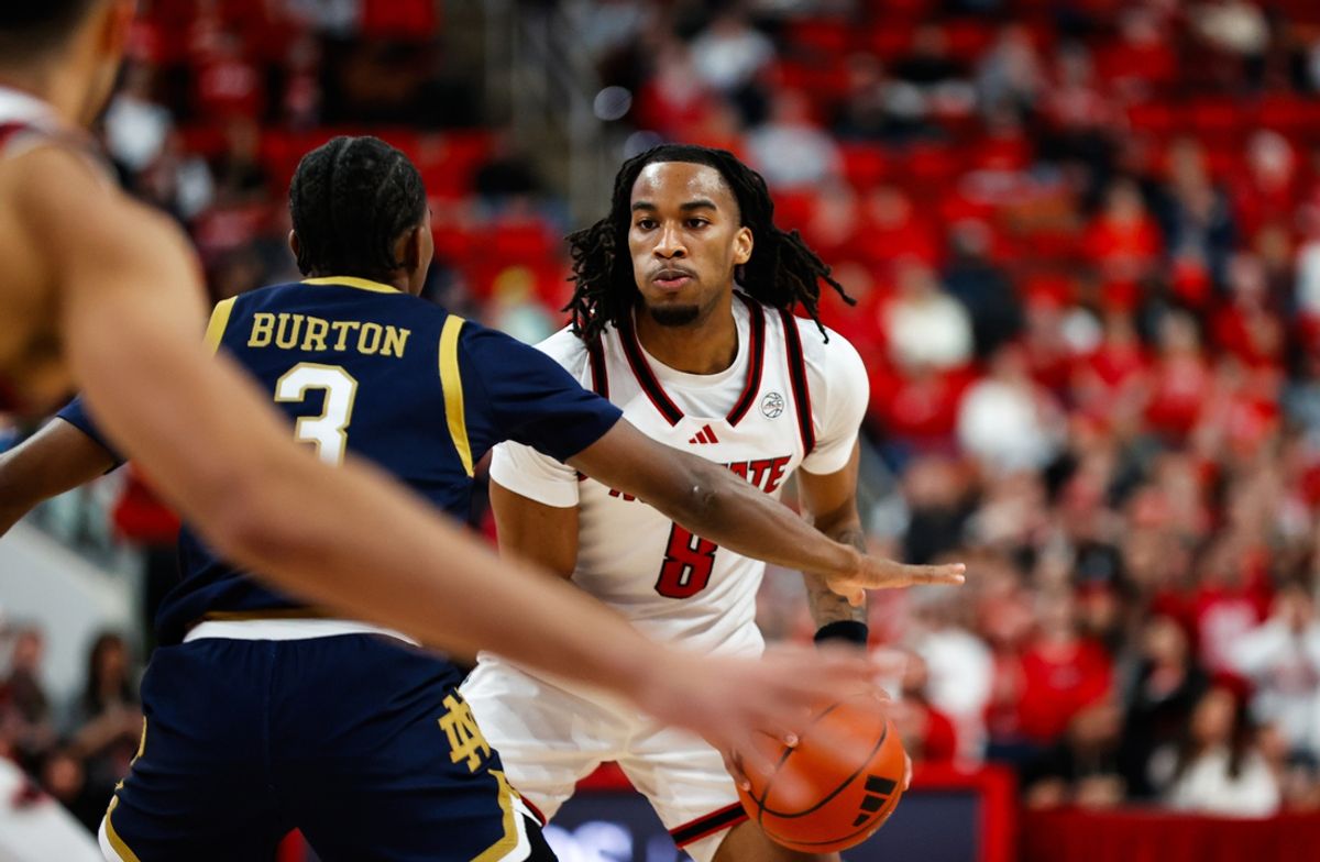 Jan 8, 2025; Raleigh, North Carolina, USA; North Carolina State Wolfpack guard Jayden Taylor (8) holds the ball during the first half against the Notre Dame Fighting Irish at Lenovo Center. Mandatory Credit: Jaylynn Nash-Imagn Images