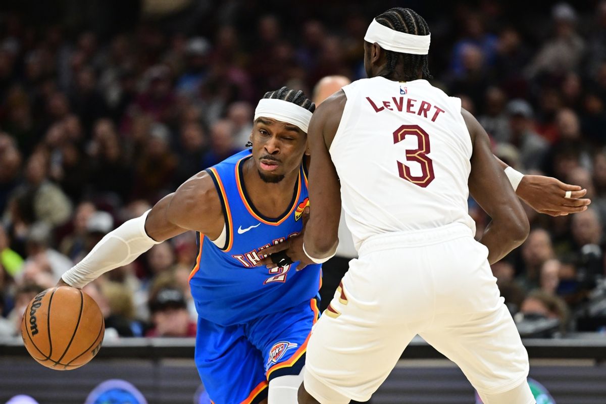 Jan 8, 2025; Cleveland, Ohio, USA; Oklahoma City Thunder guard Shai Gilgeous-Alexander (2) drives to the basket against Cleveland Cavaliers guard Caris LeVert (3) during the first half at Rocket Mortgage FieldHouse. Mandatory Credit: Ken Blaze-Imagn Images