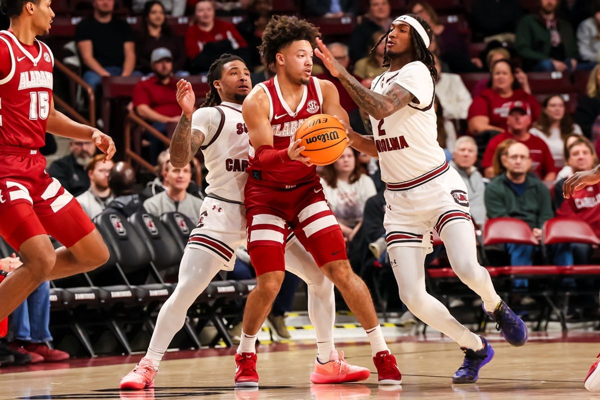 Jan 8, 2025; Columbia, South Carolina, USA; South Carolina Gamecocks guard Jamarii Thomas (6) and guard Zachary Davis (2) defend Alabama Crimson Tide guard Mark Sears (1) in the first half at Colonial Life Arena. Mandatory Credit: Jeff Blake-Imagn Images