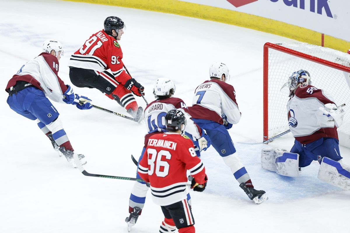 Jan 8, 2025; Chicago, Illinois, USA; Chicago Blackhawks center Frank Nazar (91) scores against Colorado Avalanche goaltender Trent Miner (50) during the second period at United Center. Mandatory Credit: Kamil Krzaczynski-Imagn Images