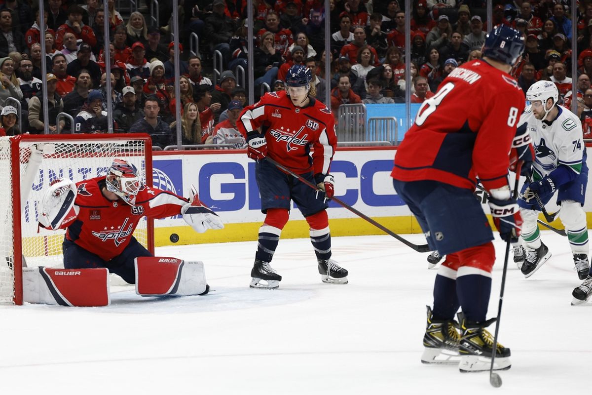 Jan 8, 2025; Washington, District of Columbia, USA; Washington Capitals goaltender Logan Thompson (48) makes a save on Vancouver Canucks left wing Jake DeBrusk (74) in the second period at Capital One Arena. Mandatory Credit: Geoff Burke-Imagn Images