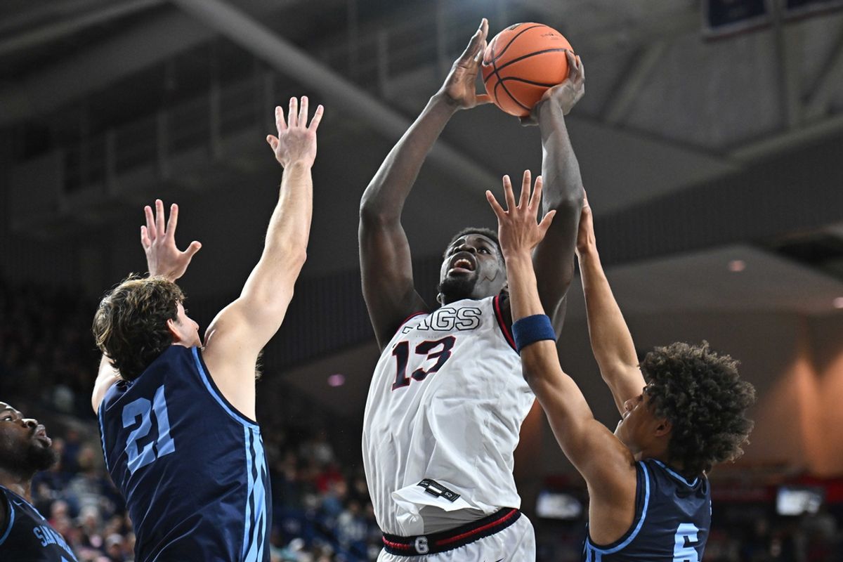 Jan 8, 2025; Spokane, Washington, USA; Gonzaga Bulldogs forward Graham Ike (13) puts up a shot against San Diego Toreros guard Kody Clouet (21) and guard Tony Duckett (6) in the first half at McCarthey Athletic Center. Mandatory Credit: James Snook-Imagn Images