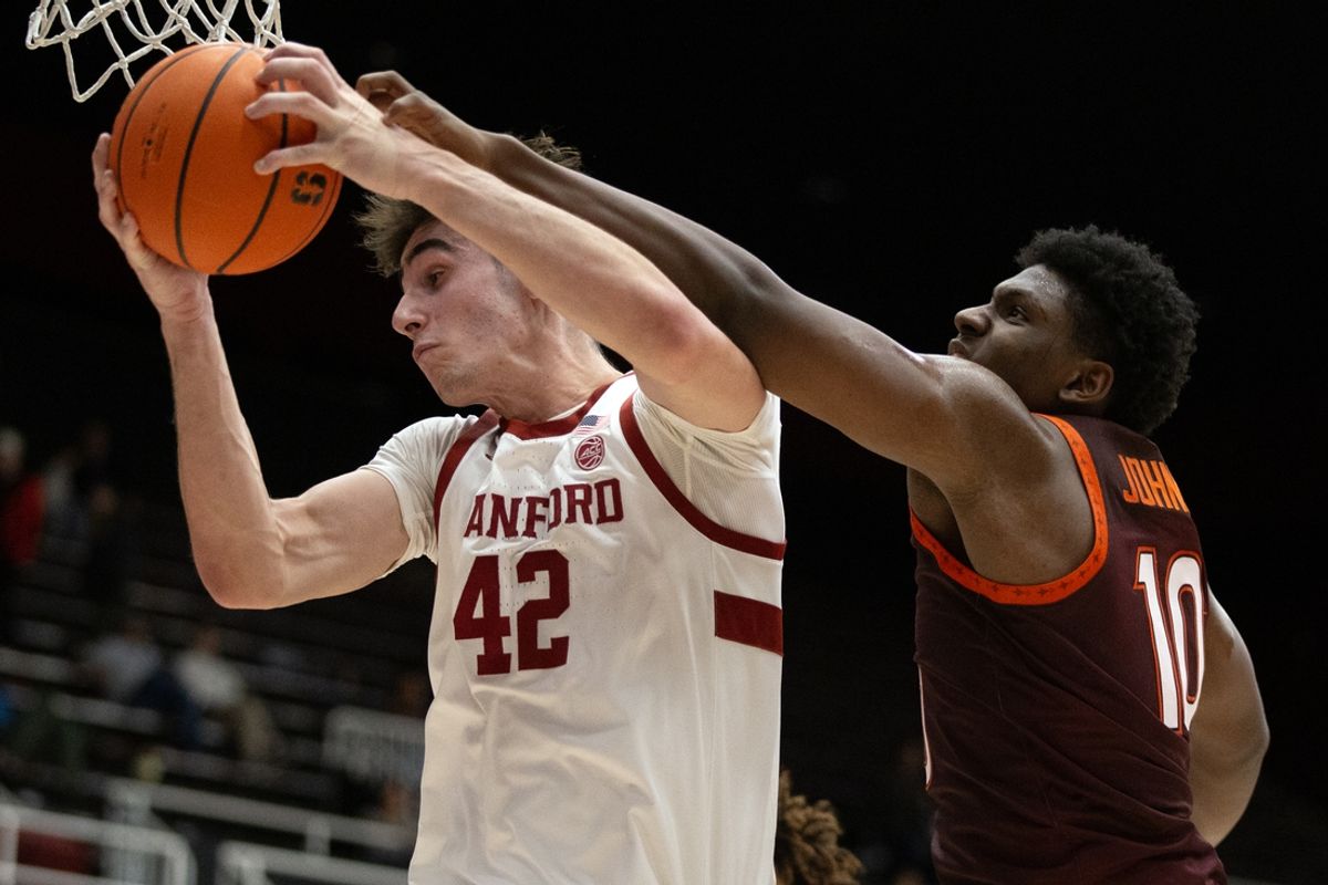 Jan 8, 2025; Stanford, California, USA; Stanford Cardinal forward Maxime Raynaud (42) secures a rebound ahead of Virginia Tech Hokies guard Tyler Johnson (10) during the first half at Maples Pavilion. Mandatory Credit: D. Ross Cameron-Imagn Images