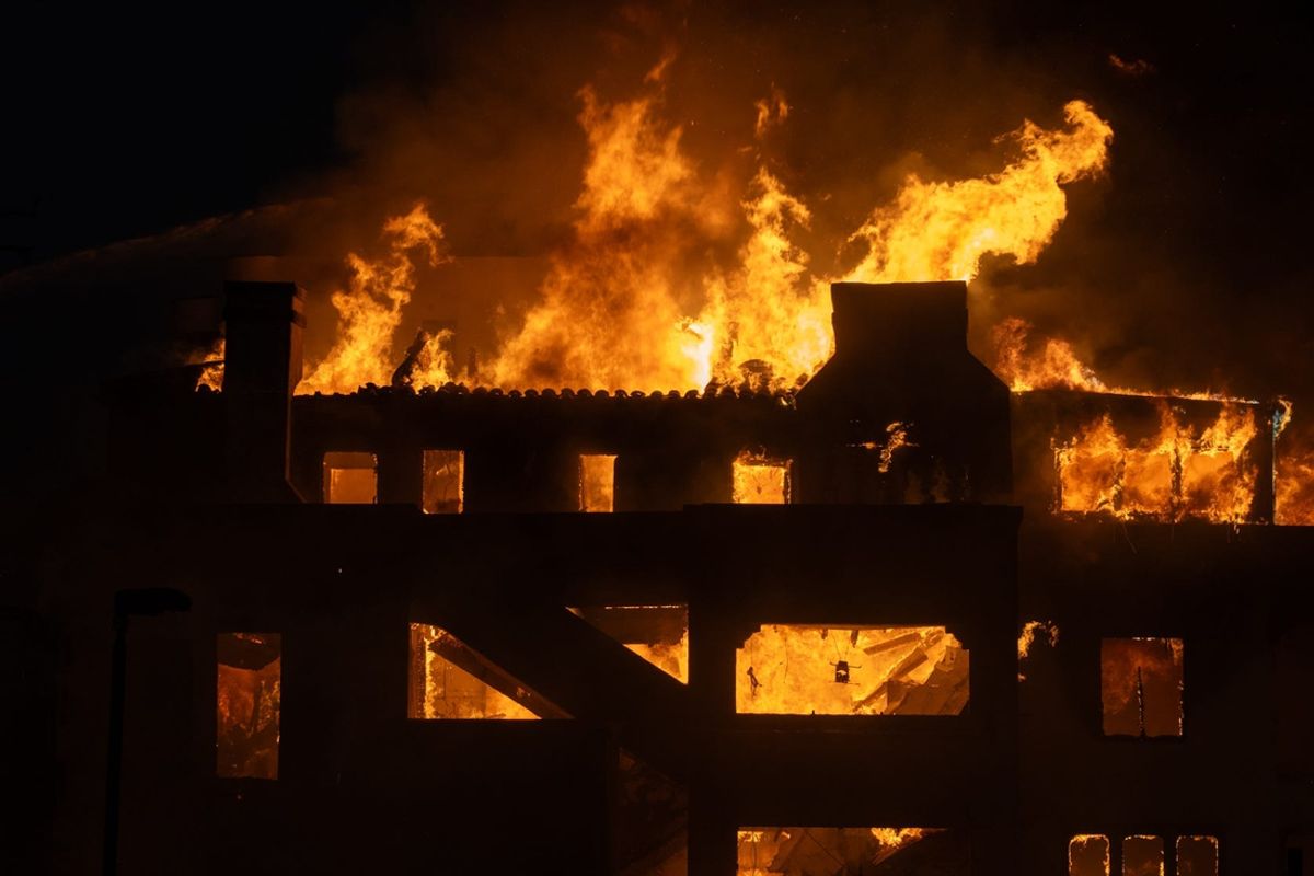 Firefighters attempt to extinguish a fire in a home along the Pacific Coast Highway in the Pacific Palisades neighborhood on Jan. 8, 2025. A wildfire broke out in Los Angeles County on Jan. 7, which has destroyed more than 1,000 homes, businesses and other structures, Los Angeles County Fire Chief Anthony Marrone said at a briefing Wednesday.