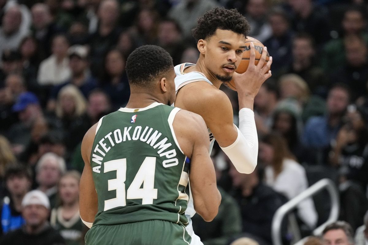 Jan 8, 2025; Milwaukee, Wisconsin, USA;  San Antonio Spurs forward Victor Wembanyama (1) holds the ball away from Milwaukee Bucks forward Giannis Antetokounmpo (34) during the second quarter at Fiserv Forum. Mandatory Credit: Jeff Hanisch-Imagn Images