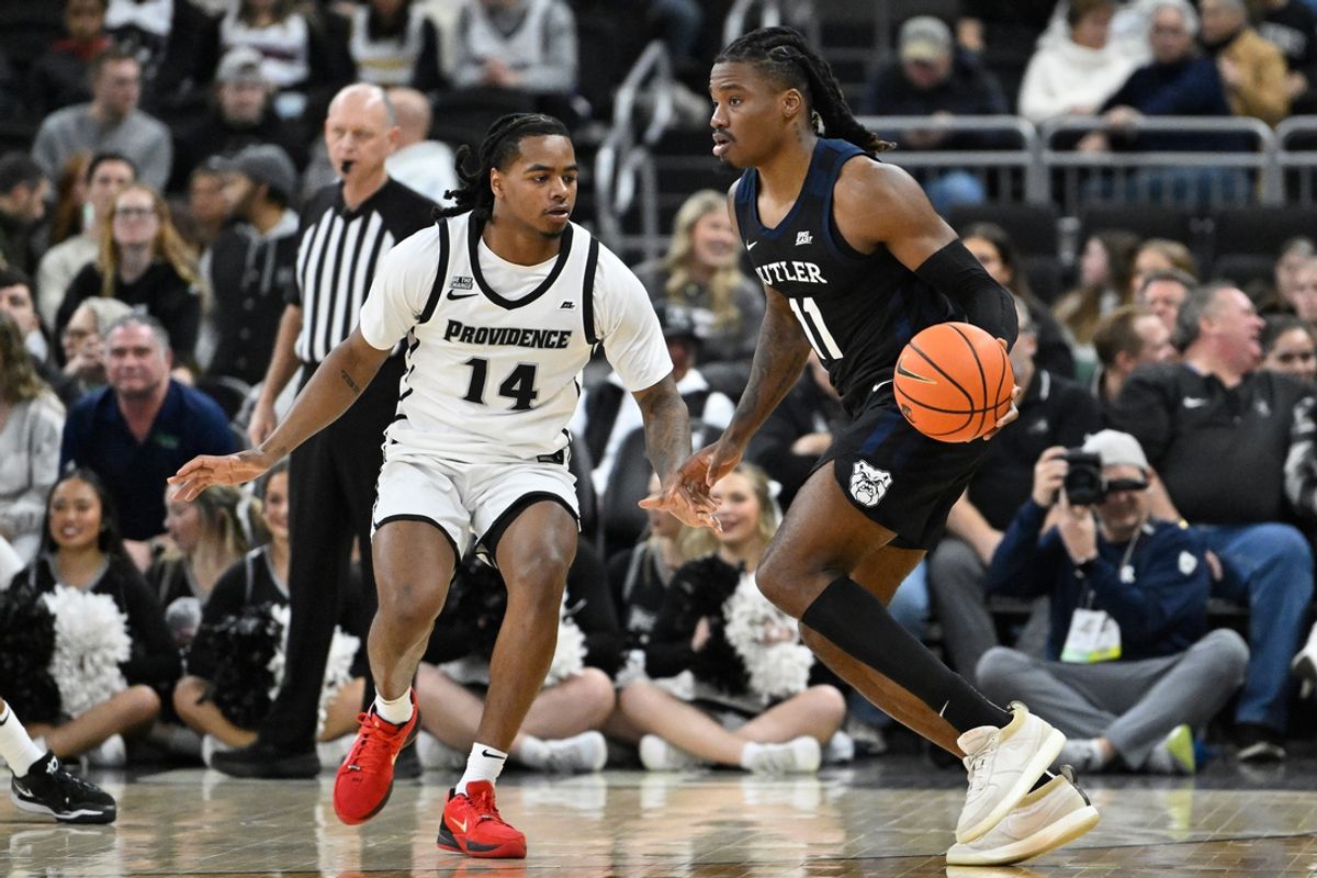 Jan 8, 2025; Providence, Rhode Island, USA; Butler Bulldogs forward Jahmyl Telfort (11) dribbles against Providence Friars guard Corey Floyd Jr. (14) during the first half at Amica Mutual Pavilion. Mandatory Credit: Eric Canha-Imagn Images