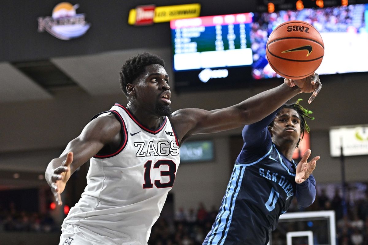 Jan 8, 2025; Spokane, Washington, USA; Gonzaga Bulldogs forward Graham Ike (13) rebounds against San Diego Toreros guard Kjay Bradley Jr. (0) in the second half at McCarthey Athletic Center. Gonzaga Bulldogs won 93-80. Mandatory Credit: James Snook-Imagn Images