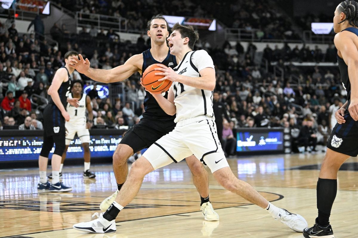 Jan 8, 2025; Providence, Rhode Island, USA; Providence Friars forward Ryan Mela (11) drives against Butler Bulldogs forward Boden Kapke (33) during the first half at Amica Mutual Pavilion. Mandatory Credit: Eric Canha-Imagn Images