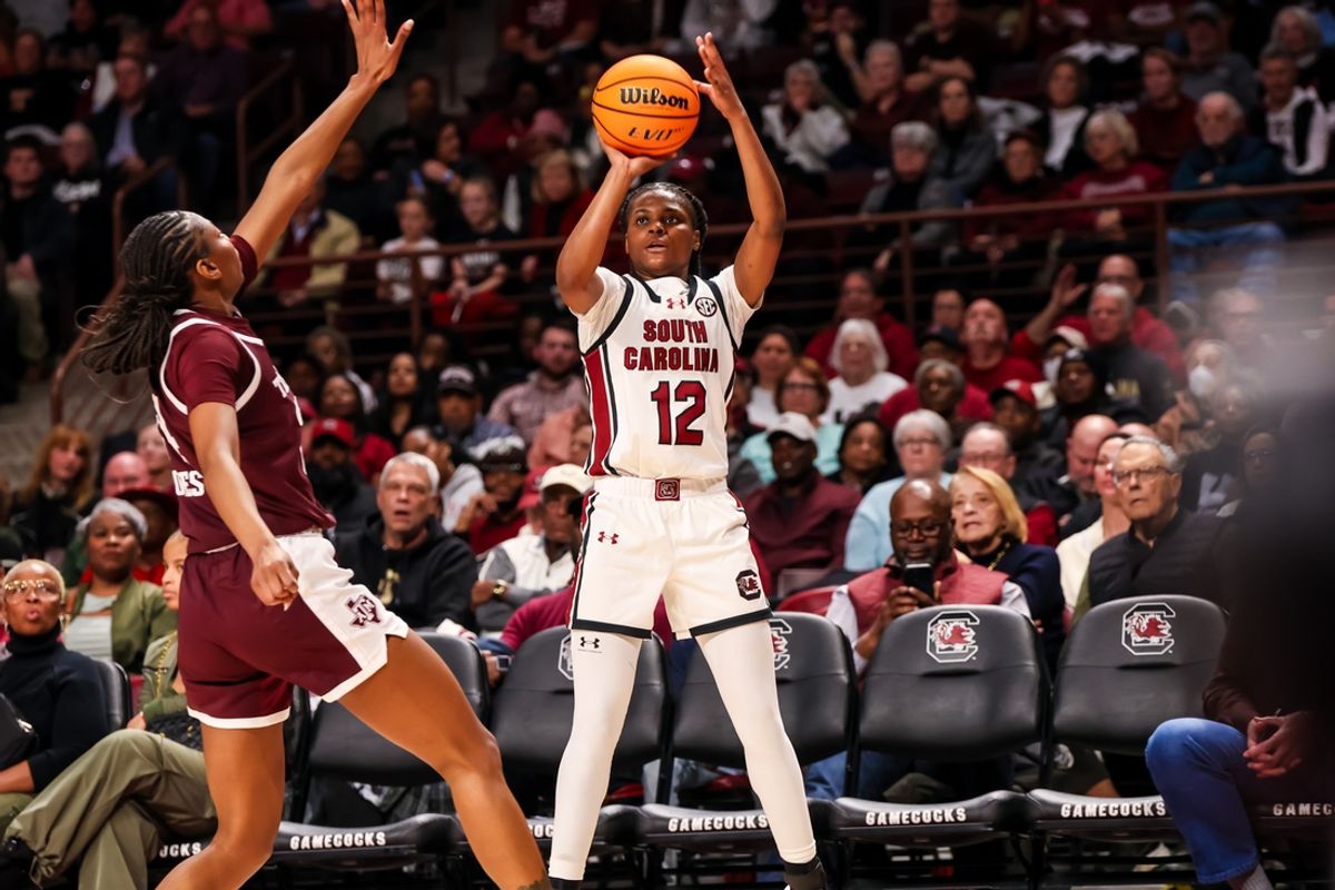 Jan 9, 2025; Columbia, South Carolina, USA; South Carolina Gamecocks guard MiLaysia Fulwiley (12) makes a three-point basket over Texas A&M Aggies guard Sahara Jones (24) in the second half at Colonial Life Arena. Mandatory Credit: Jeff Blake-Imagn Images