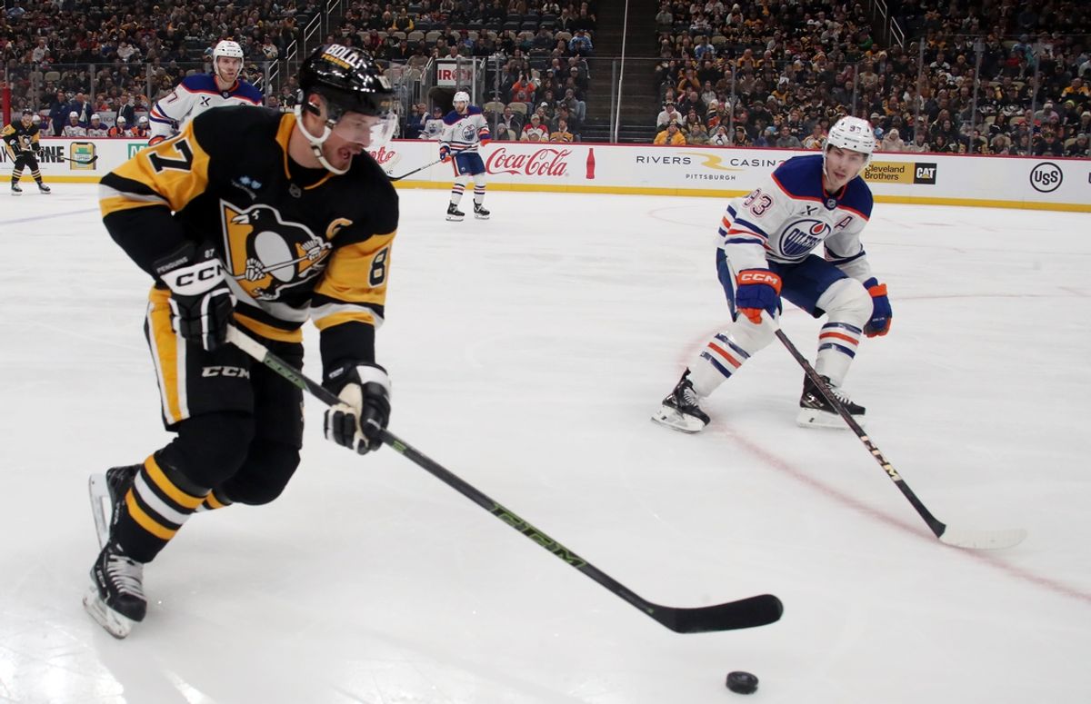 Jan 9, 2025; Pittsburgh, Pennsylvania, USA;  Pittsburgh Penguins center Sidney Crosby (87) skates with the puck against the Edmonton Oilers during the first period at PPG Paints Arena. Mandatory Credit: Charles LeClaire-Imagn Images