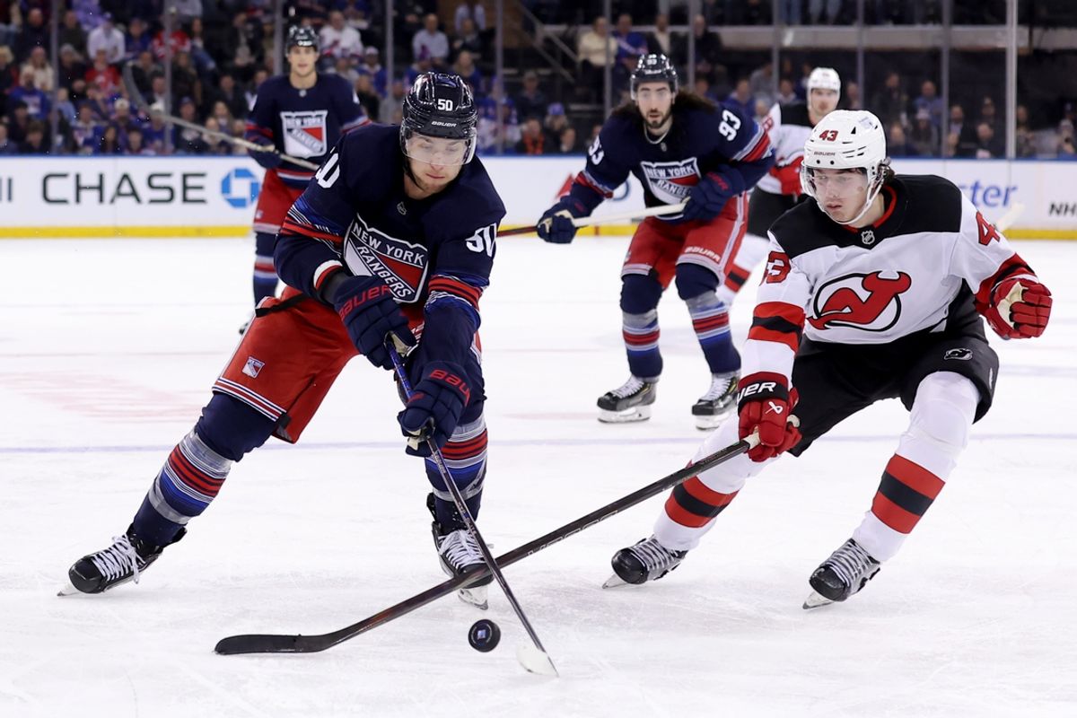 Jan 9, 2025; New York, New York, USA; New York Rangers left wing Will Cuylle (50) fights for the puck against New Jersey Devils defenseman Luke Hughes (43) during the second period at Madison Square Garden. Mandatory Credit: Brad Penner-Imagn Images