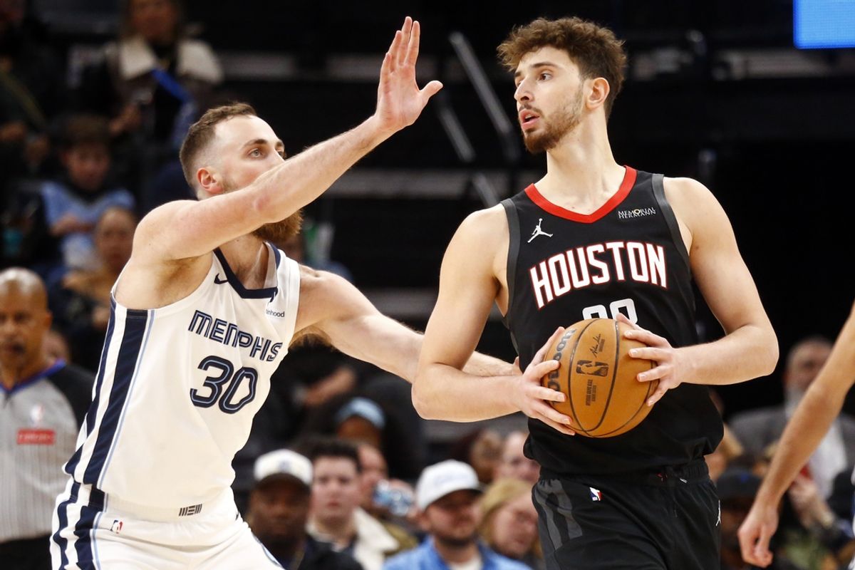 Jan 9, 2025; Memphis, Tennessee, USA; Houston Rockets center Alperen Sengun (28) handles the ball as Memphis Grizzlies center Jay Huff (30) defends during the second quarter at FedExForum. Mandatory Credit: Petre Thomas-Imagn Images