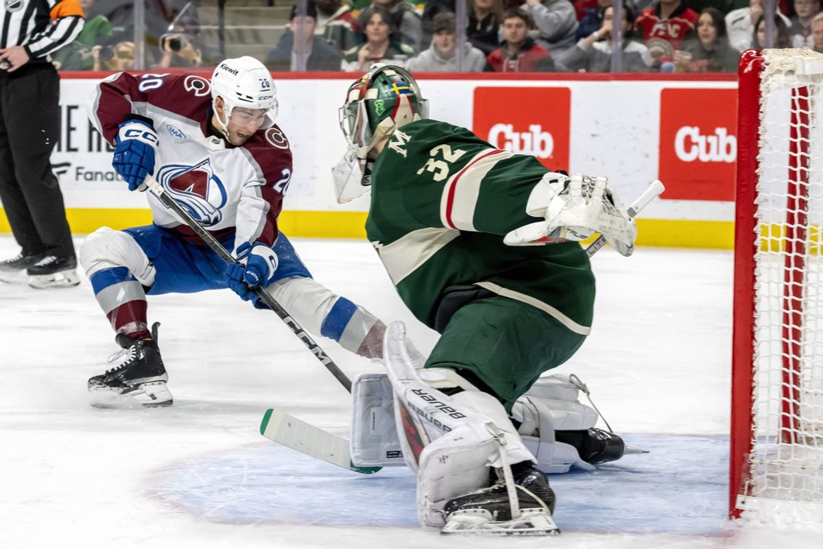 Jan 9, 2025; Saint Paul, Minnesota, USA;  Minnesota Wild goalie Filip Gustavsson (32) makes a save on Colorado Avalanche forward Ross Colton (20) during the second period at Xcel Energy Center. Mandatory Credit: Nick Wosika-Imagn Images