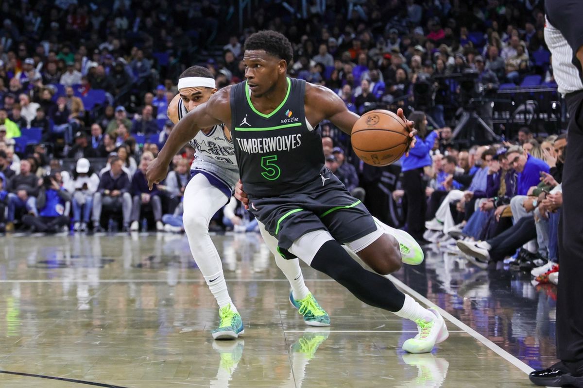 Jan 9, 2025; Orlando, Florida, USA; Minnesota Timberwolves guard Anthony Edwards (5) drives past Orlando Magic guard Trevelin Queen (12) during the second half at Kia Center. Mandatory Credit: Mike Watters-Imagn Images