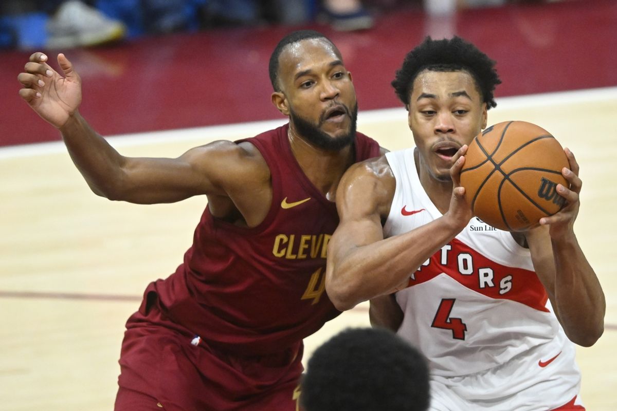 Jan 9, 2025; Cleveland, Ohio, USA; Cleveland Cavaliers forward Evan Mobley (4) defends Toronto Raptors forward Scottie Barnes (4) in the fourth quarter at Rocket Mortgage FieldHouse. Mandatory Credit: David Richard-Imagn Images