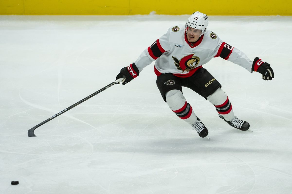 Jan 9, 2025; Ottawa, Ontario, CAN; Ottawa Senators center Nick Cousins (21) reaches for the puck in the third period against the Buffalo Sabres at the Canadian Tire Centre. Mandatory Credit: Marc DesRosiers-Imagn Images