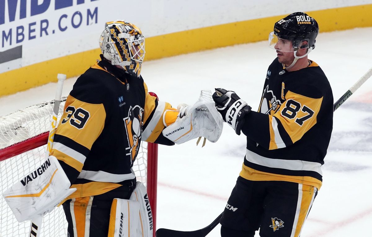 Jan 9, 2025; Pittsburgh, Pennsylvania, USA;  Pittsburgh Penguins goaltender Alex Nedeljkovic (39) and center Sidney Crosby (87) celebrate after defeating the Edmonton Oilers at PPG Paints Arena. Mandatory Credit: Charles LeClaire-Imagn Images