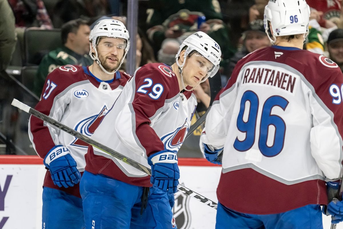 Jan 9, 2025; Saint Paul, Minnesota, USA;  Colorado Avalanche forward Nathan MacKinnon (29) celebrates his goal against the Minnesota Wild with Colorado Avalanche forward Jonathan Drouin (27) and Colorado Avalanche forward Mikko Rantanen (96) during the third period at Xcel Energy Center. Mandatory Credit: Nick Wosika-Imagn Images