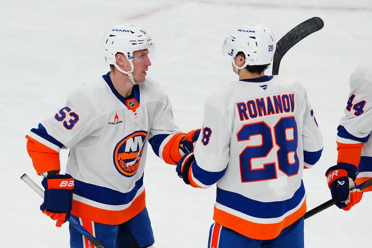Jan 9, 2025; Las Vegas, Nevada, USA; New York Islanders center Casey Cizikas (53) celebrates with New York Islanders defenseman Alexander Romanov (28) after scoring an empty net goal against the Vegas Golden Knights during the third period at T-Mobile Arena. Mandatory Credit: Stephen R. Sylvanie-Imagn Images