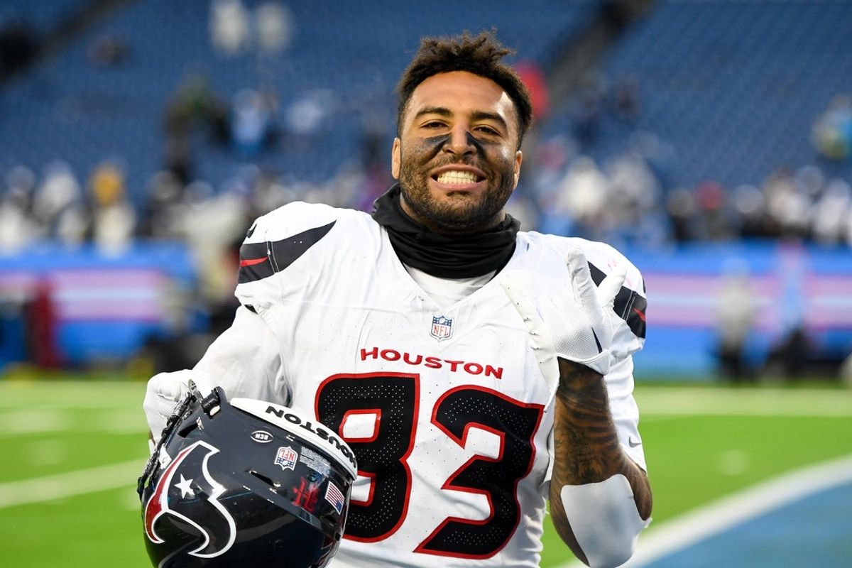 Jan 5, 2025; Nashville, Tennessee, USA;  Houston Texans tight end Irv Smith Jr. (83) all smiles as he leaves the field against the Tennessee Titans during the second half at Nissan Stadium. Mandatory Credit: Steve Roberts-Imagn Images