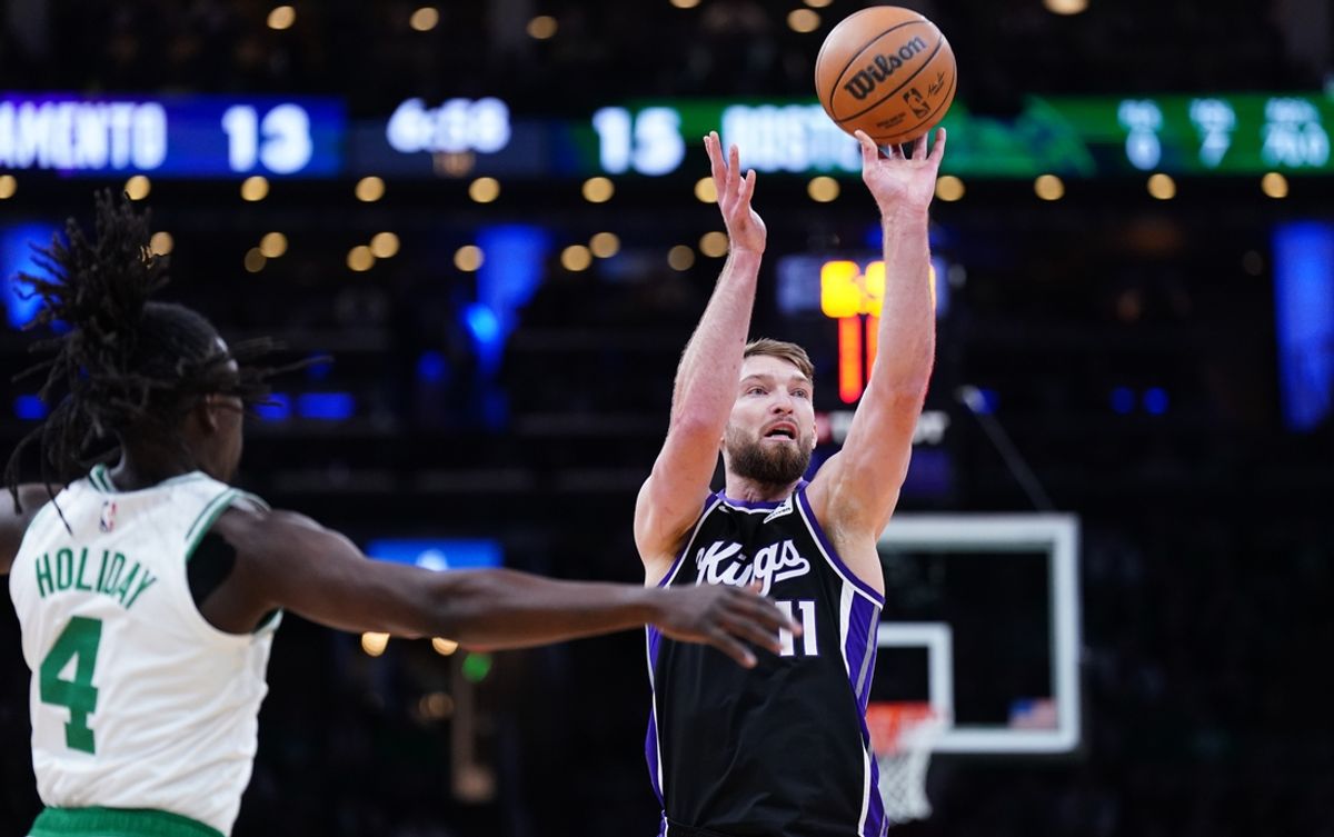 Jan 10, 2025; Boston, Massachusetts, USA; Sacramento Kings forward Domantas Sabonis (11) shoots against Boston Celtics guard Jrue Holiday (4) in the first quarter at TD Garden. Mandatory Credit: David Butler II-Imagn Images