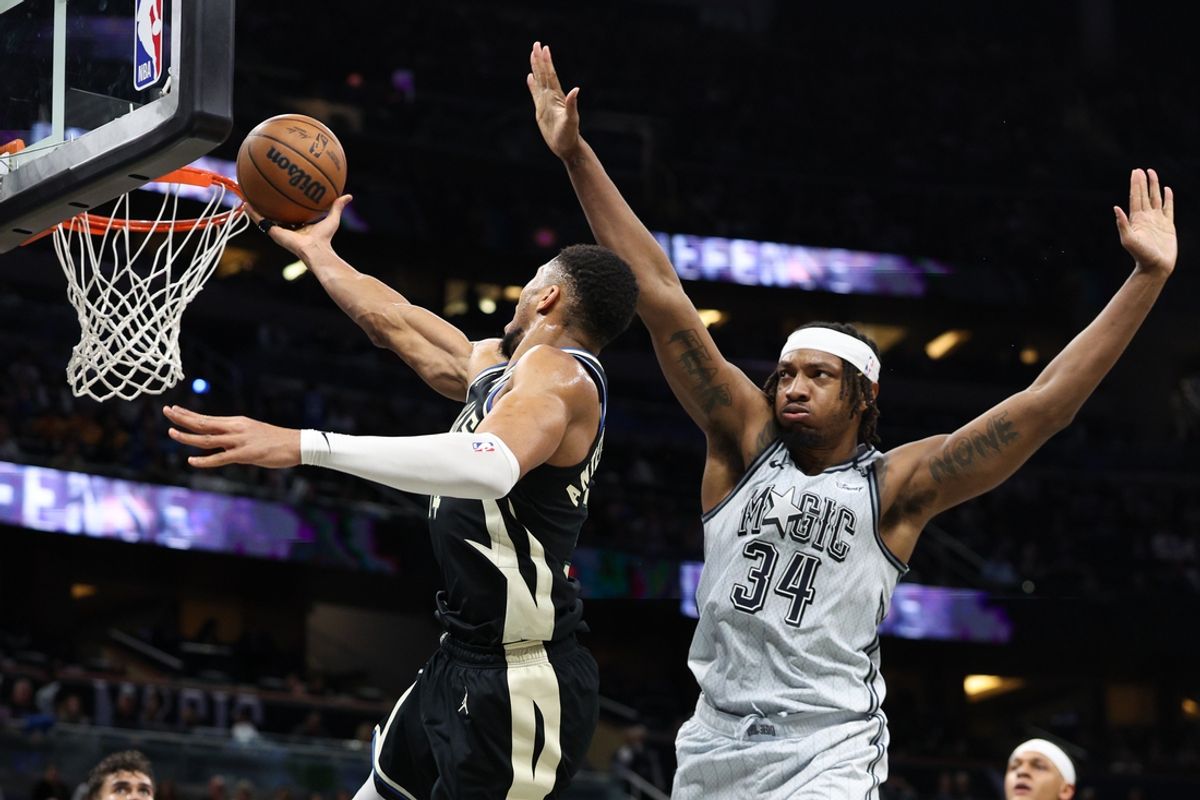 Jan 10, 2025; Orlando, Florida, USA; Milwaukee Bucks forward Giannis Antetokounmpo (34) drives to the basket past Orlando Magic center Wendell Carter Jr. (34) in the second quarter at Kia Center. Mandatory Credit: Nathan Ray Seebeck-Imagn Images