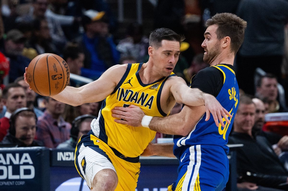Jan 10, 2025; Indianapolis, Indiana, USA; Indiana Pacers guard T.J. McConnell (9) dribbles the ball while Golden State Warriors guard Pat Spencer (61) defends in the first half at Gainbridge Fieldhouse. Mandatory Credit: Trevor Ruszkowski-Imagn Images