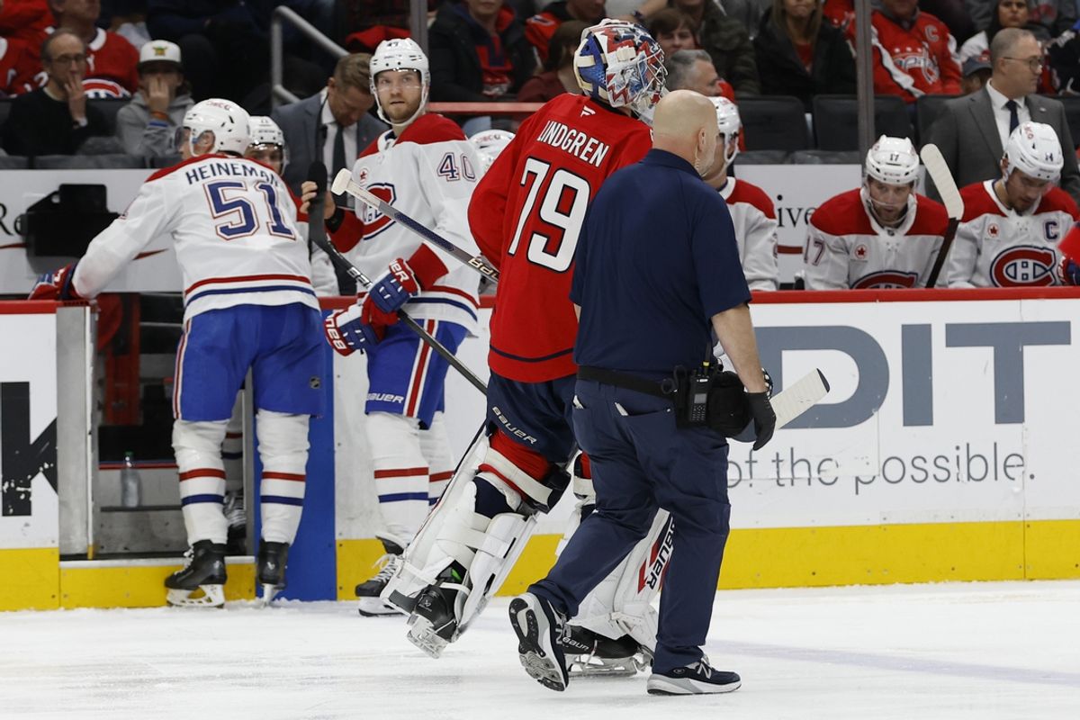 Jan 10, 2025; Washington, District of Columbia, USA; Washington Capitals goaltender Charlie Lindgren (79) is assisted off the ice by Capitals trainer Jason Serbus after being injured against the Montreal Canadiens in the second period at Capital One Arena. Mandatory Credit: Geoff Burke-Imagn Images